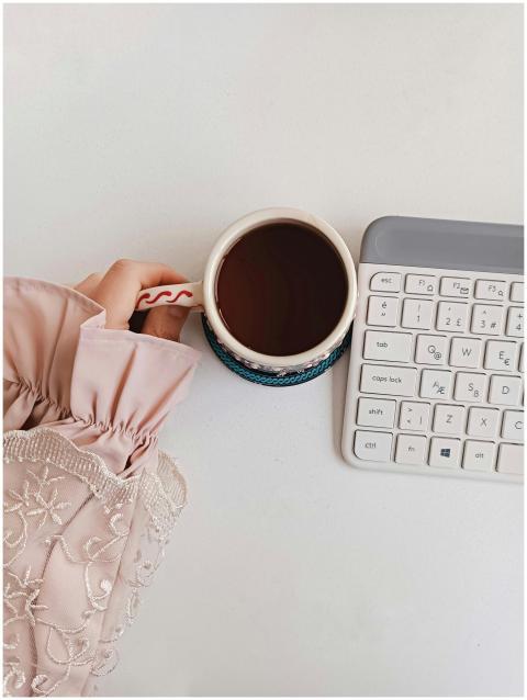 Stylish workspace with coffee, keyboard, and lace