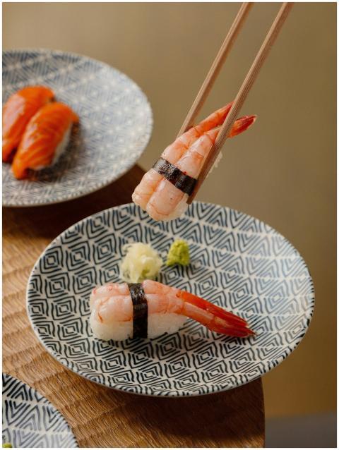 Close-up of shrimp nigiri sushi on patterned plate