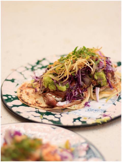 Delicious fish taco garnished with vibrant cabbage