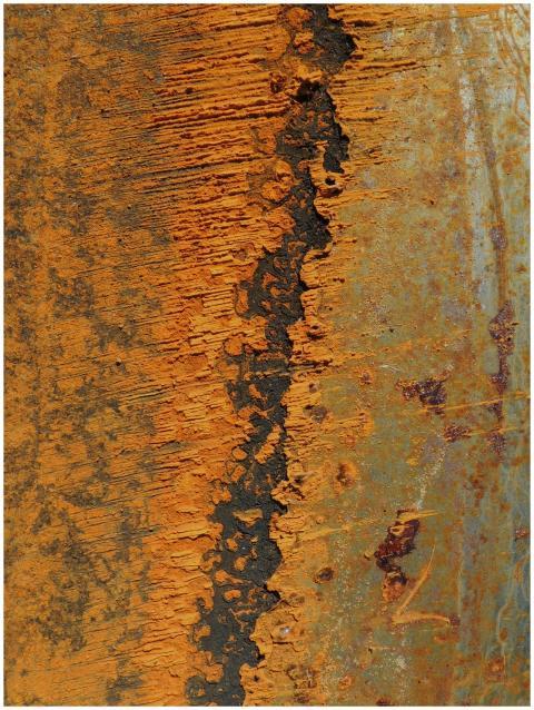 Detailed close-up of a rusty metal surface with pe
