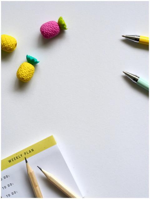 Flat lay of colorful stationery including pens, pe