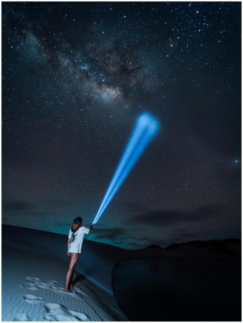 Person illuminates Milky Way with flashlight in Ma