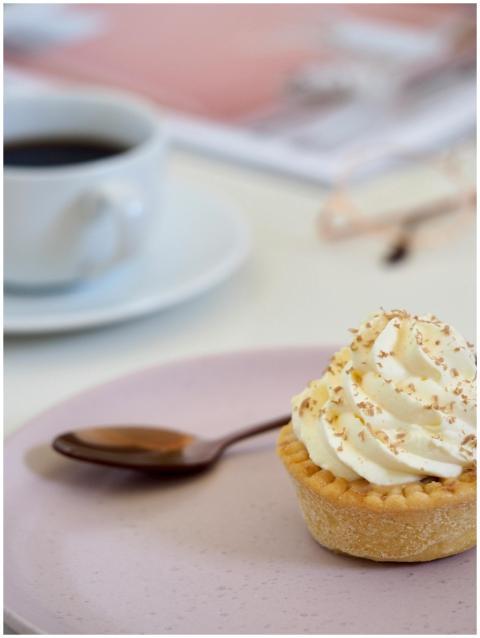 Luscious creamy tart on a plate with coffee, perfe