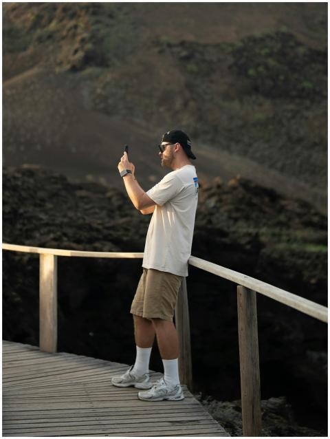 A man captures the volcanic landscape from a board