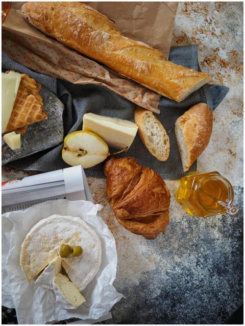 Flat lay of a French breakfast with croissant, bag
