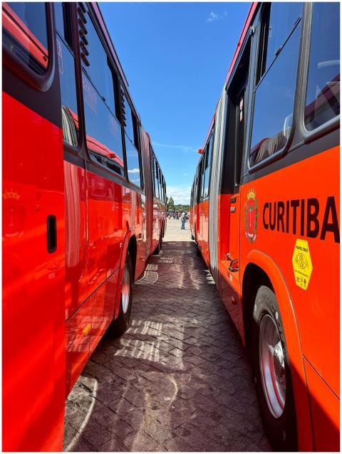 Bright red buses perfectly aligned in Curitiba, Br