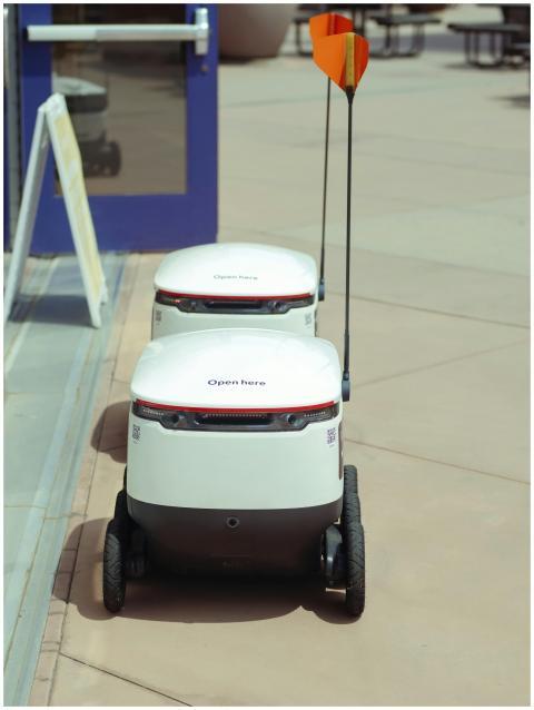 High angle view of two autonomous delivery robots