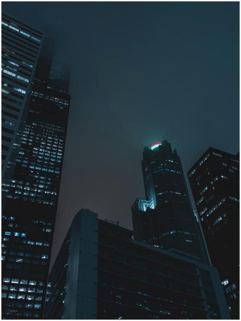 Dramatic nighttime view of towering skyscrapers in