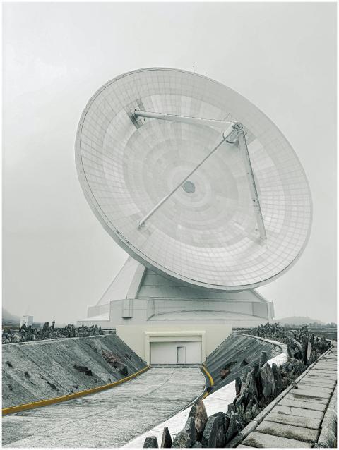 Massive radio telescope dish in a remote mountaino