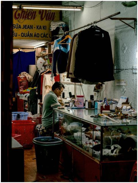 A vibrant portrayal of a tailor shop in Vietnam wi