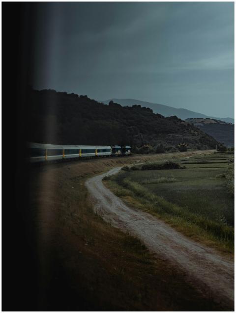Moody view of a train winding through the scenic h