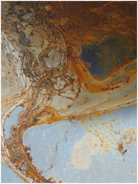 Close-up of vibrant rust patterns creating an abst