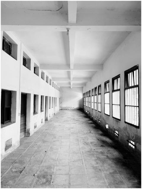 Monochrome corridor with large windows and symmetr