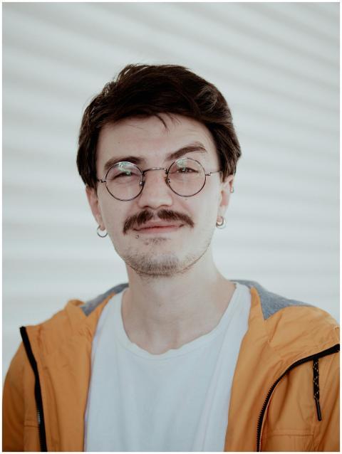 Portrait of a stylish young man with glasses weari