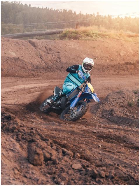 Motocross rider skillfully navigating a dirt track