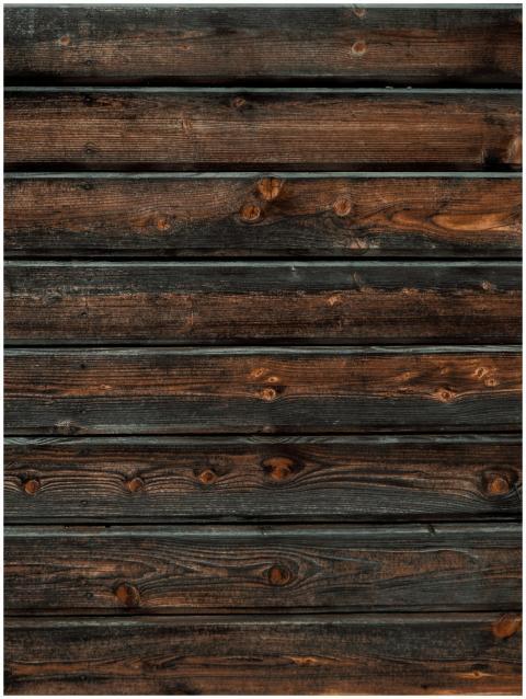 Close-up of a rustic wooden plank wall showing det