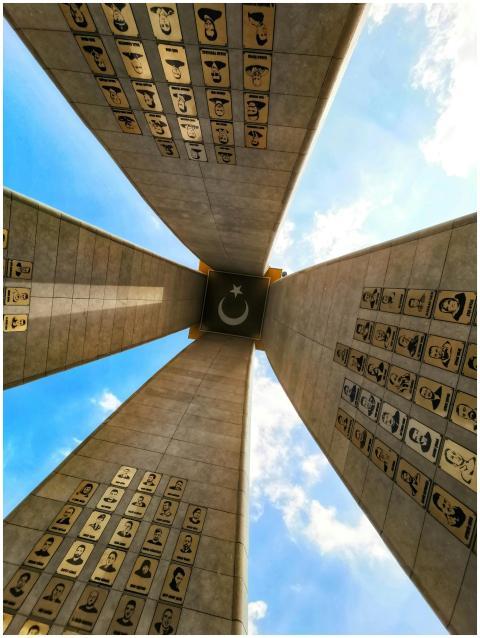 Looking up at a Turkish memorial with star and cre