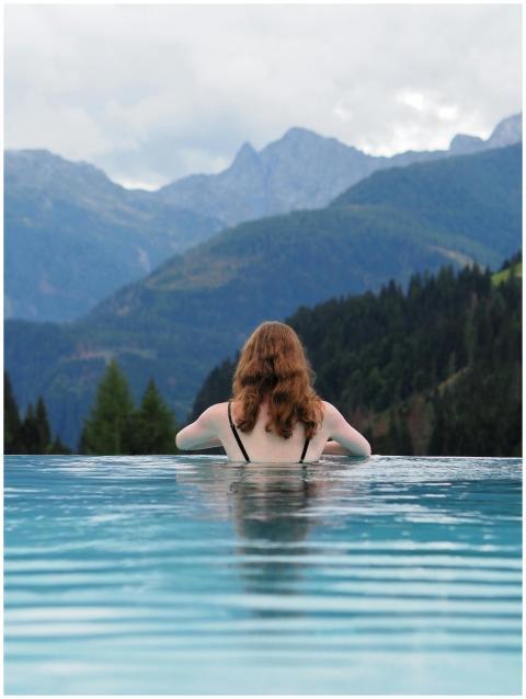 Woman enjoying a serene view from an infinity pool