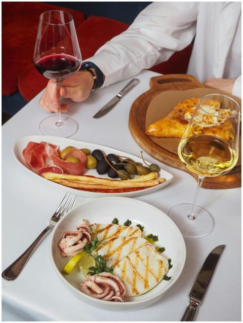 Elegant table setting with wine, antipasto platter