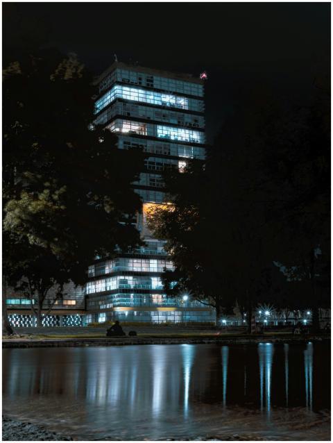 Modern high-rise building with glowing windows ref