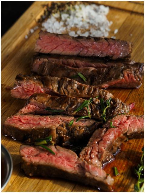 Close-up of sliced grilled steak with seasoning on