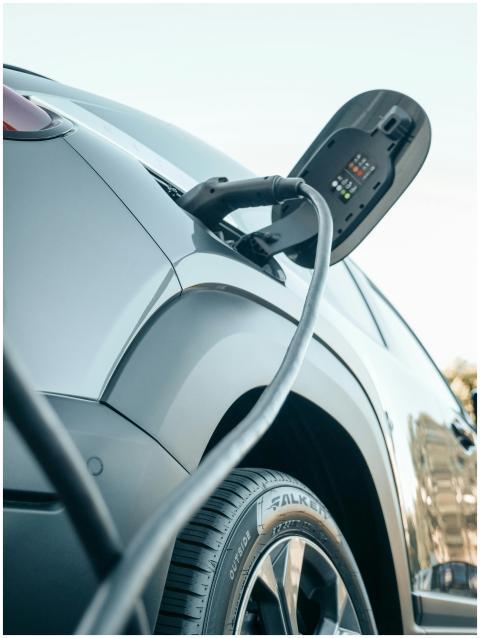 Detailed view of an electric car plugged into a ch