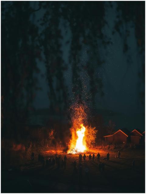 Large bonfire with people silhouetted against the