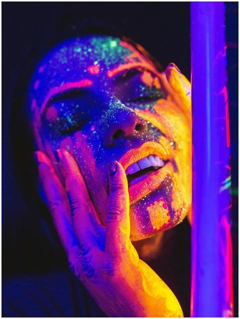 Close-up portrait of a woman with luminous neon fa