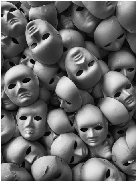 Black and white photo of numerous expressionless m