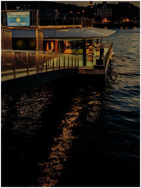 Illuminated observation deck on a river at night,
