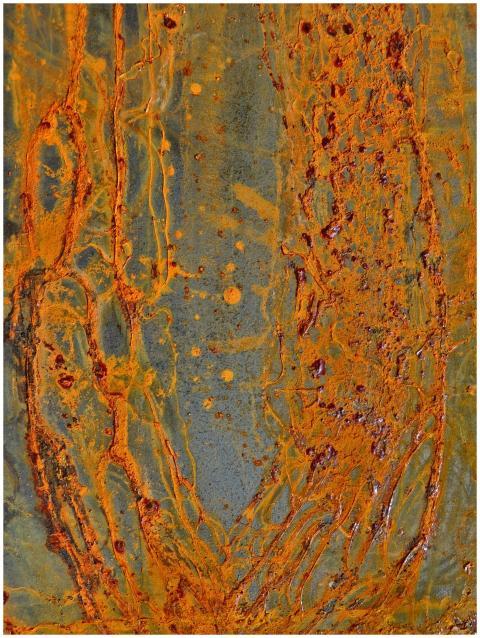 Detailed close-up of a rusty, corroded metal surfa