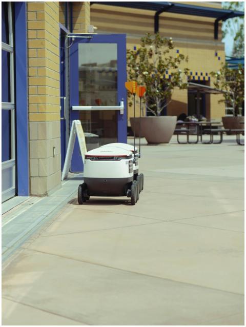 Autonomous delivery robot outside a building, show
