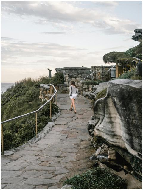 Woman walking along the scenic Bondi Beach coastal