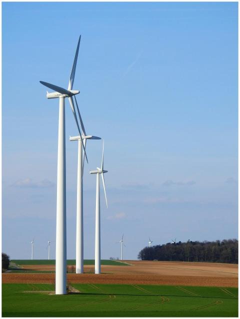 Row of wind turbines in a rural area, generating r