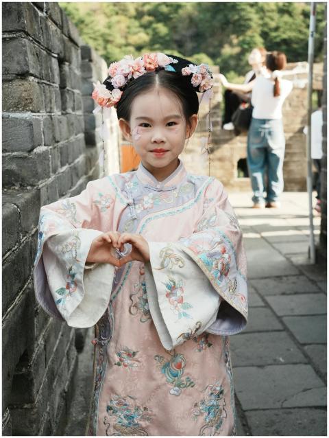 Young girl wearing traditional Hanfu poses at a hi