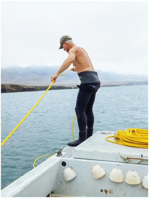 Man engaged in fishing activity from a boat using