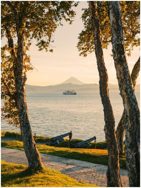 Serene sunset over a lake with distant ship and Mo