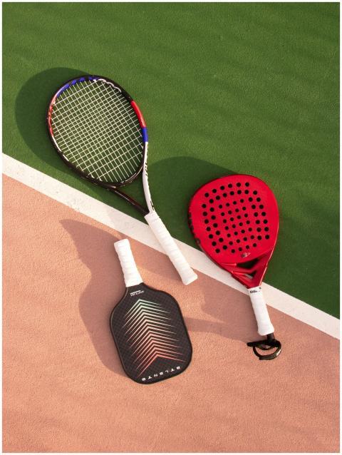 Tennis, padel, and pickleball rackets on a vibrant
