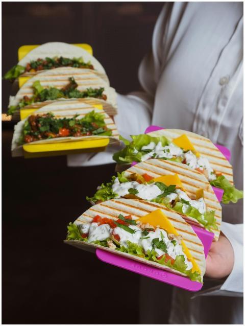 Mouth-watering tacos with fresh ingredients held b