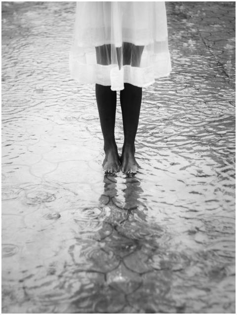 Artistic black and white photo of a barefoot woman