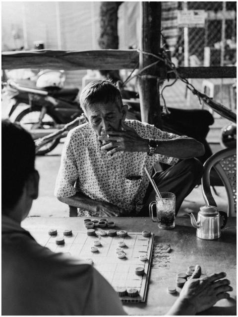 Black and white photo of seniors playing a board g