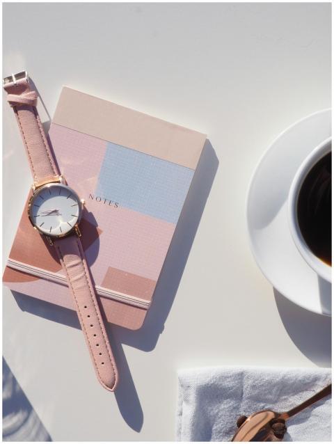 Elegant flat lay with wristwatch, notebook, and co