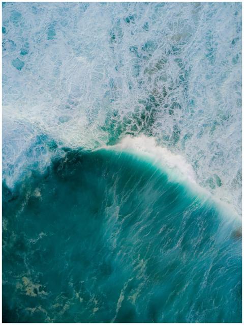 Stunning aerial shot of turquoise ocean waves cras