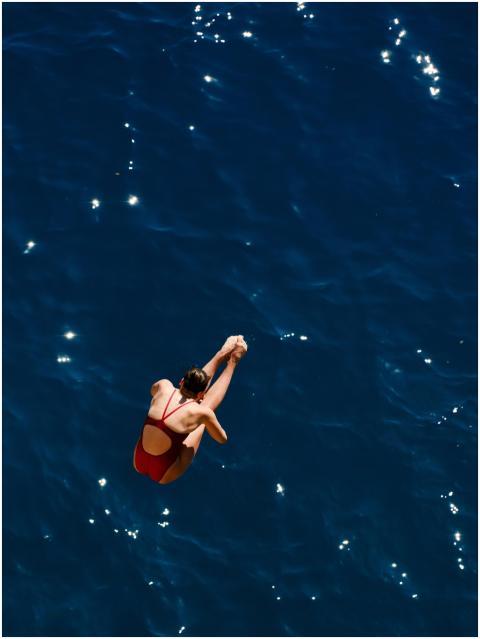 Aerial shot of a female diver in red swimwear divi