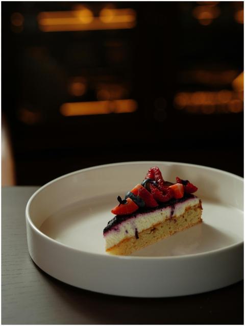 A slice of cheesecake topped with fresh berries in