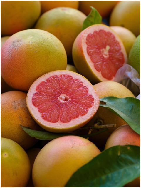 Close-up of fresh, ripe grapefruits with a sliced