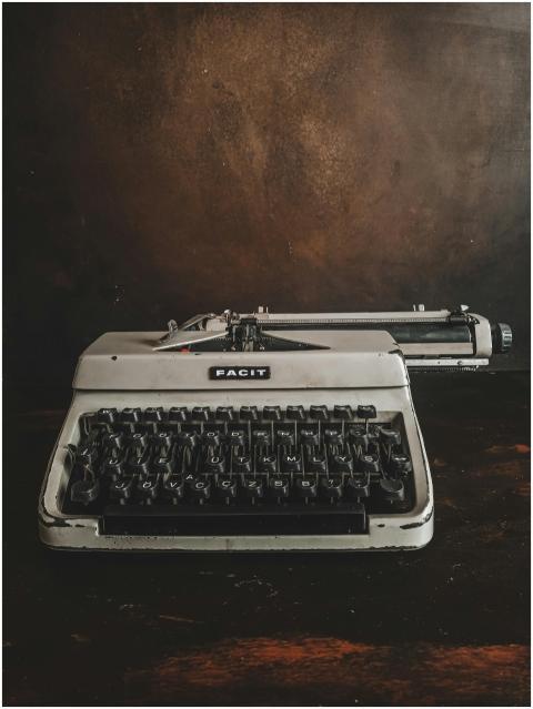 Antique Facit typewriter on a dark wooden surface,