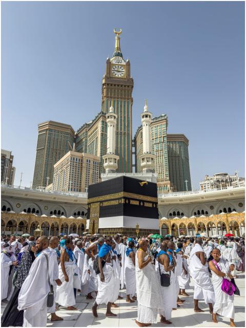 A large group of pilgrims gather at the Kaaba in M