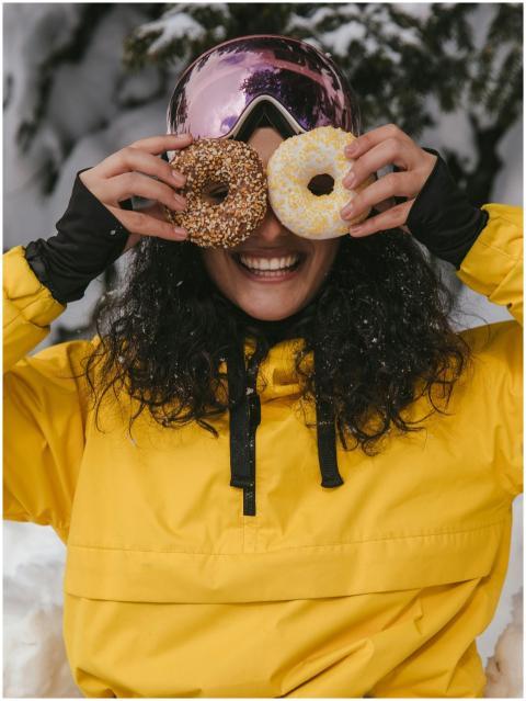Woman in a yellow jacket enjoying winter with doug