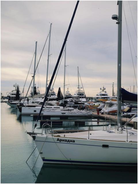 A row of luxury yachts docked at a marina under an